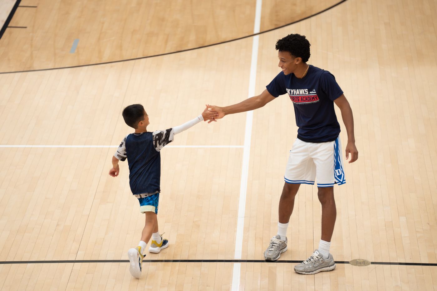 Player fist-bumping a young fan